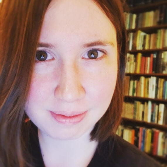 Photo of a woman in front of a bookcase.